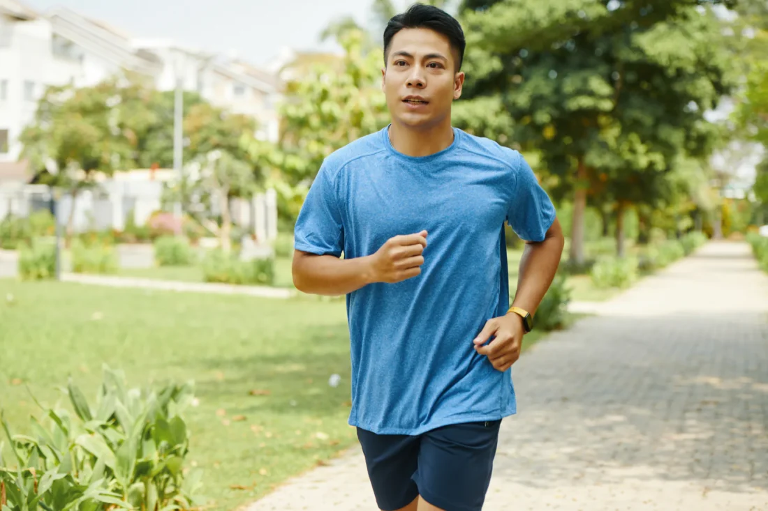 Man jogging along a park path